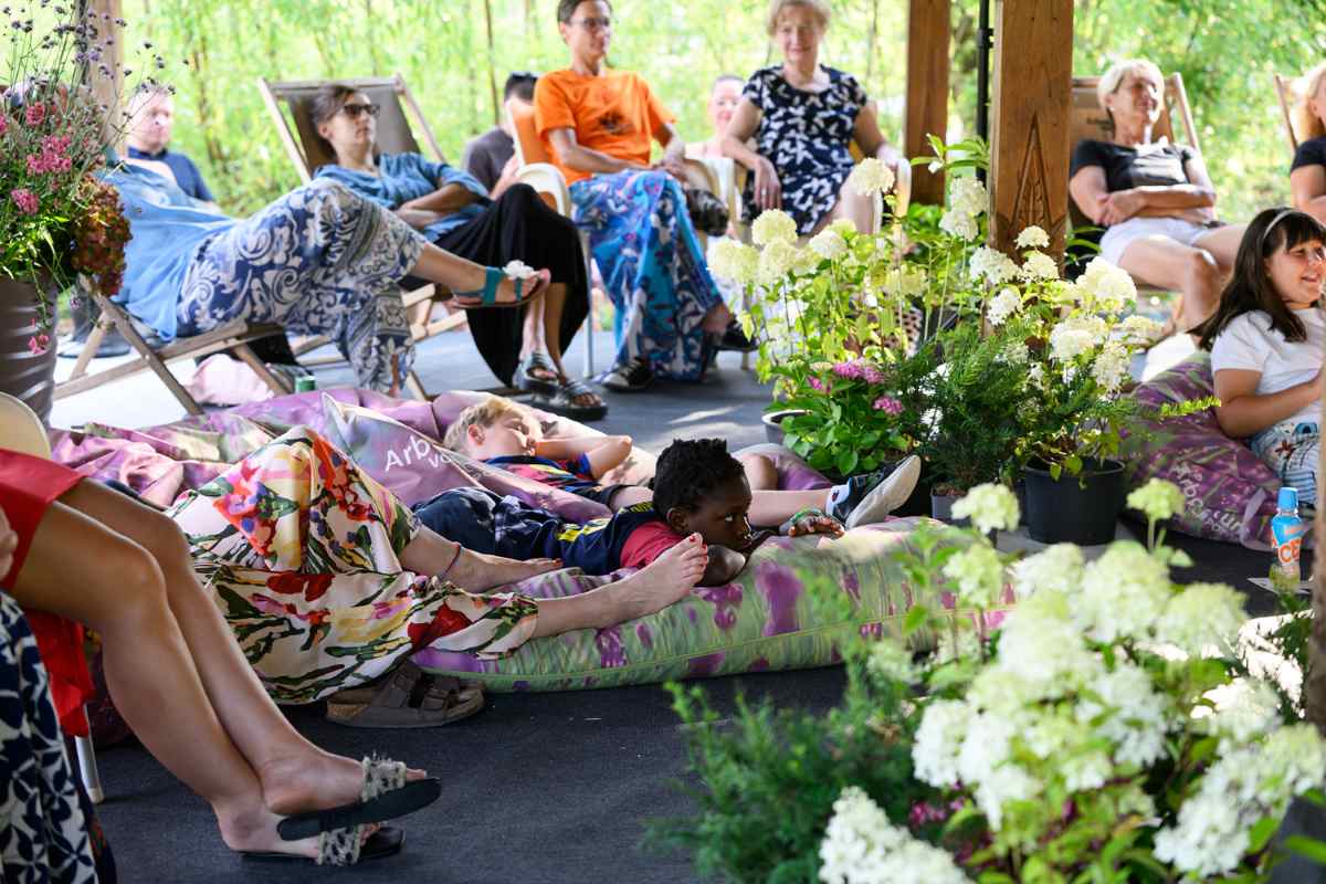 Cvetlični orkester povezuje vse generacije Foto: Katja Goljat Obiskovalci različnih generacij sedijo na ležalnikih ali počivajo na blazinah med cvetočimi rastlinami in spremljajo dogajanje pod Indonezijskim paviljonom.